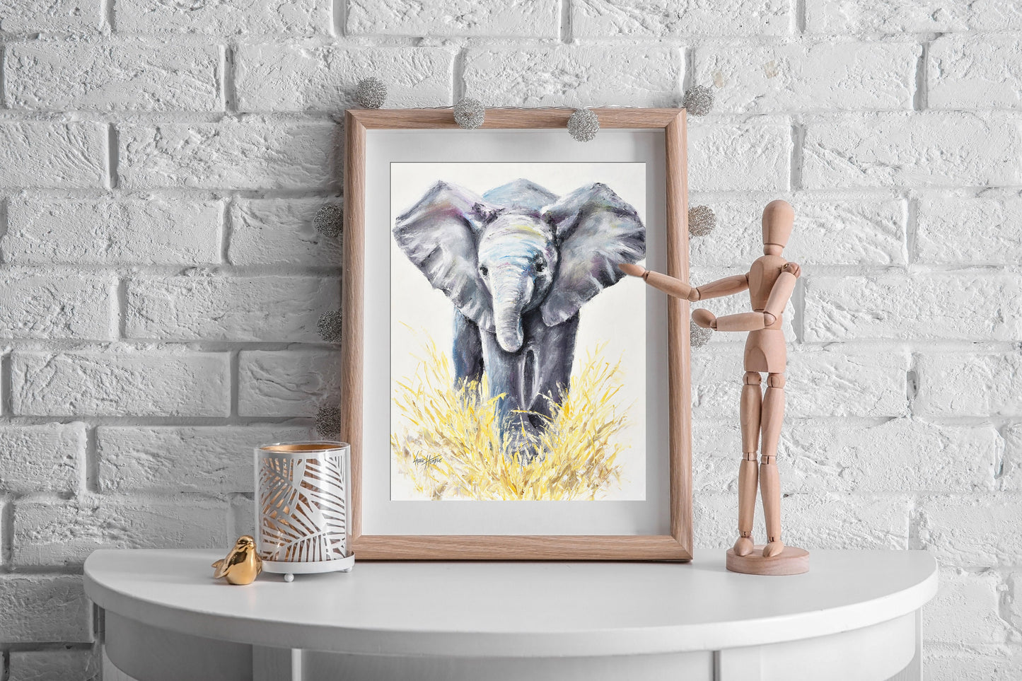 Baby elephant fine art print hanging in a safari-themed nursery